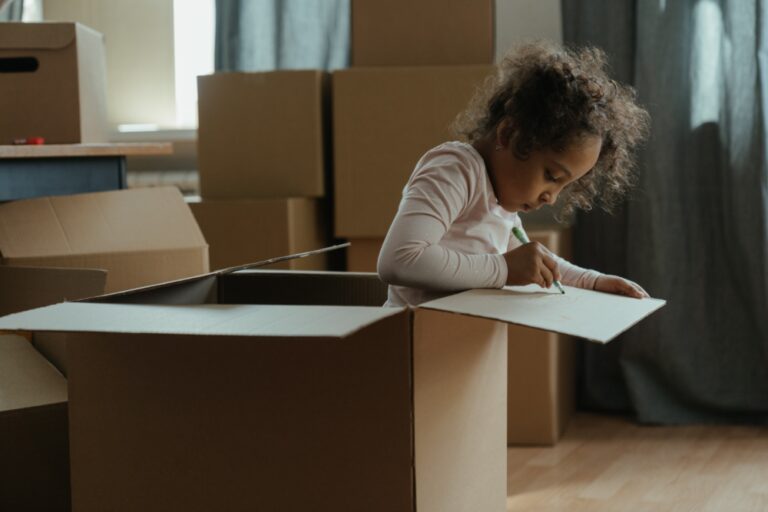 child moving boxes